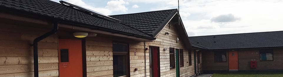 PGL Liddington Timber Frame Accommodation with Metrotile Lightweight Roofing in Bond Charcoal with retrofit Photovoltaic System