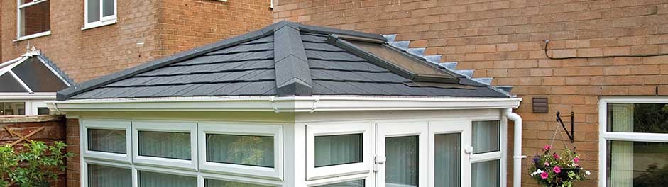 Conservatory refurbished with a Metrotile Lightweight Roof System Shingle Charcoal and Velux Window